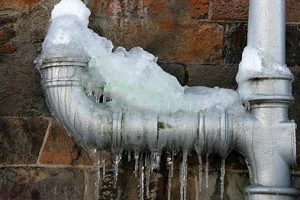 A pipe with snow and ice on it